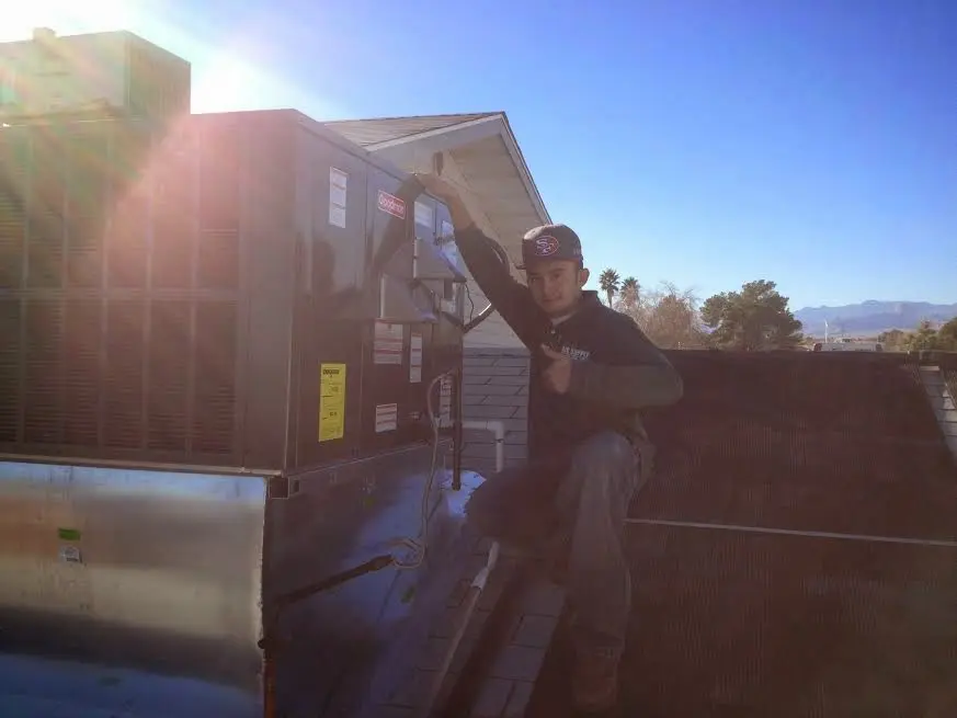 HVAC technician performing Air Duct Repair on a rooftop unit in Tamalpais-Homestead Valley